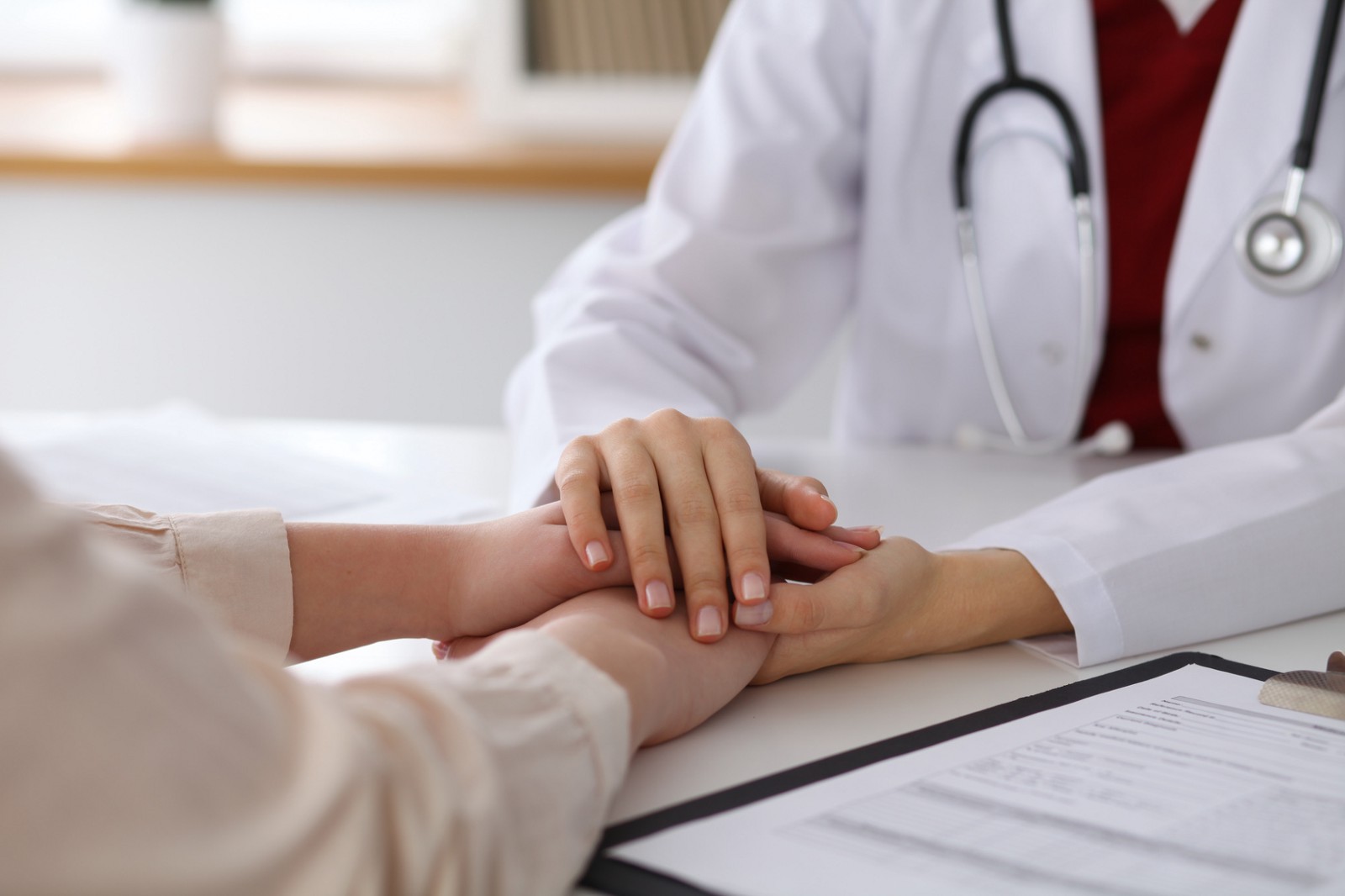 A clinician offering a reassuring gesture to a patient